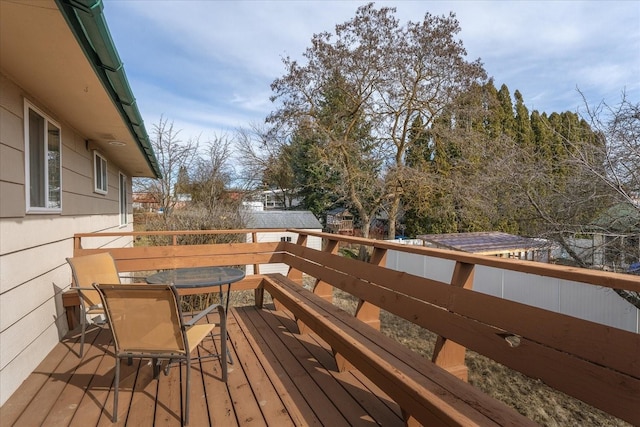 wooden terrace featuring outdoor dining space