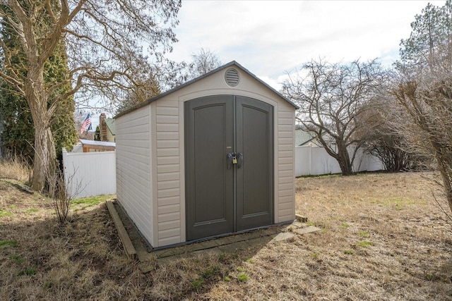 view of shed with fence