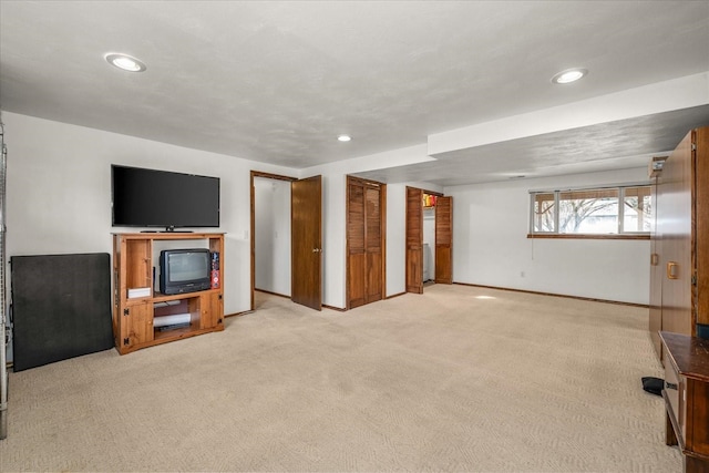 basement with recessed lighting, baseboards, and light carpet