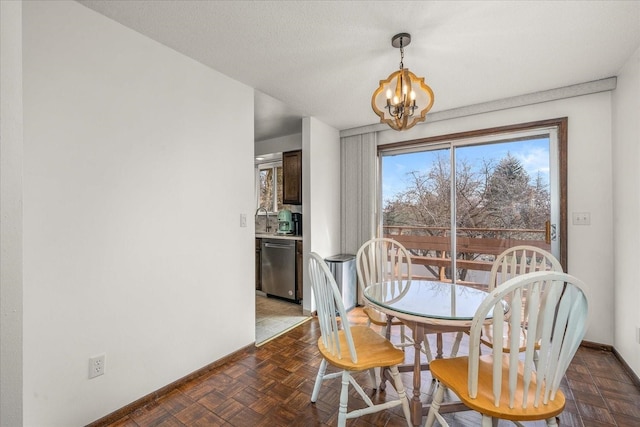 dining space with a chandelier and baseboards