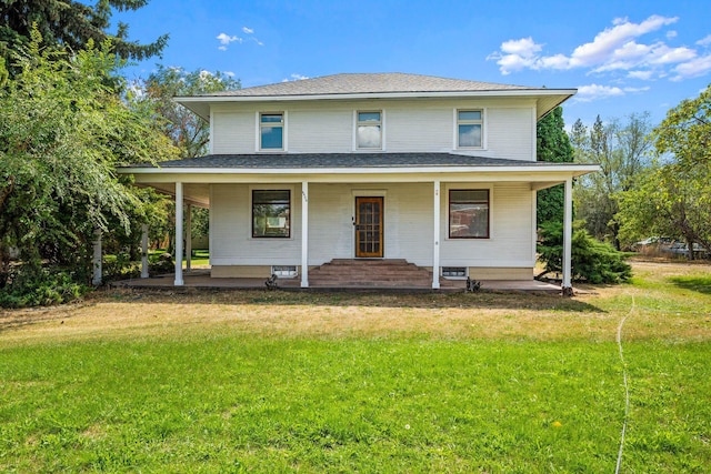 view of front of house with roof with shingles, covered porch, and a front lawn