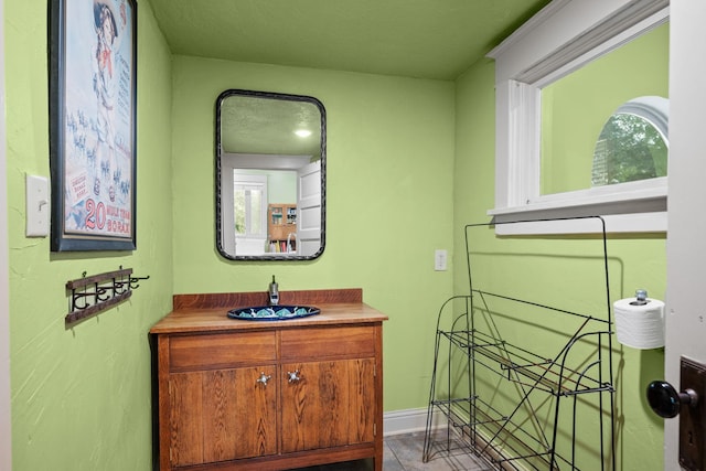 bathroom with vanity and baseboards