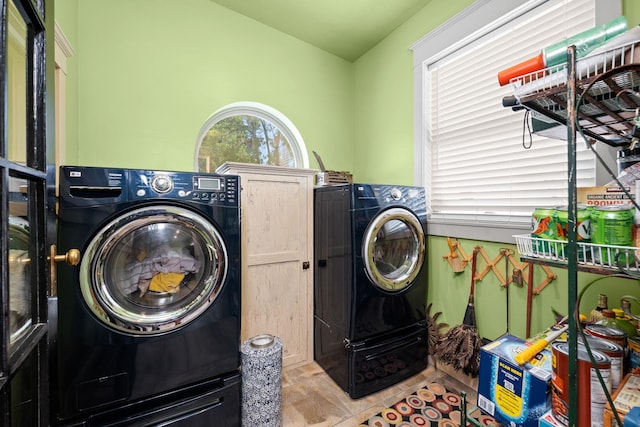 laundry room with washer and clothes dryer and cabinet space