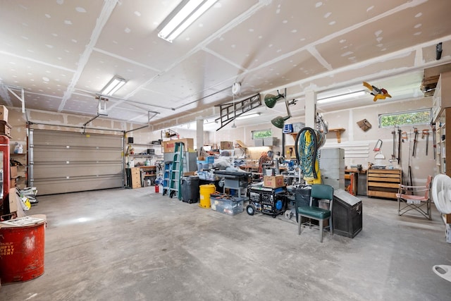 garage with a workshop area and a garage door opener