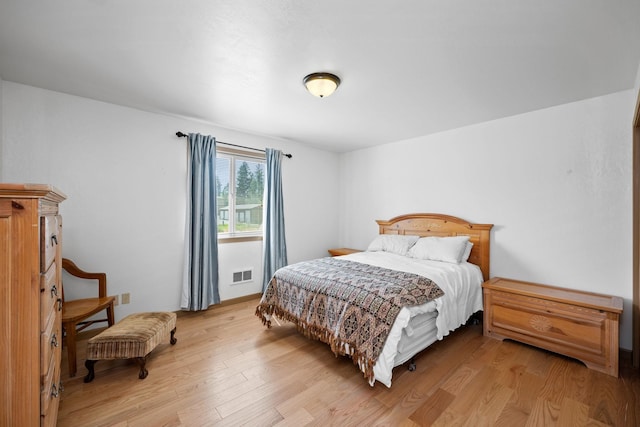 bedroom with visible vents and light wood-style flooring