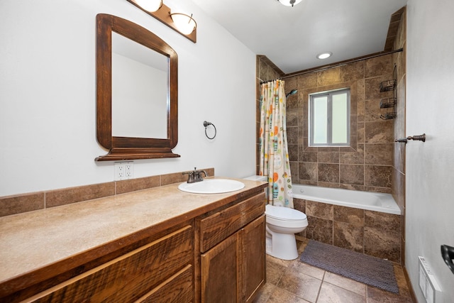 full bathroom featuring visible vents, toilet, vanity, and tiled shower / bath