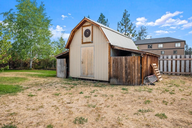 view of barn with fence