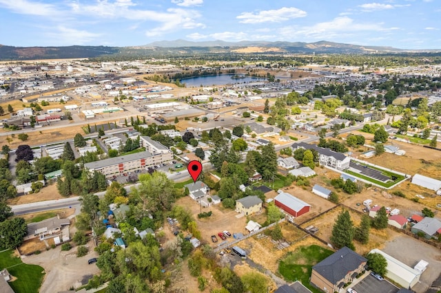 birds eye view of property with a water and mountain view