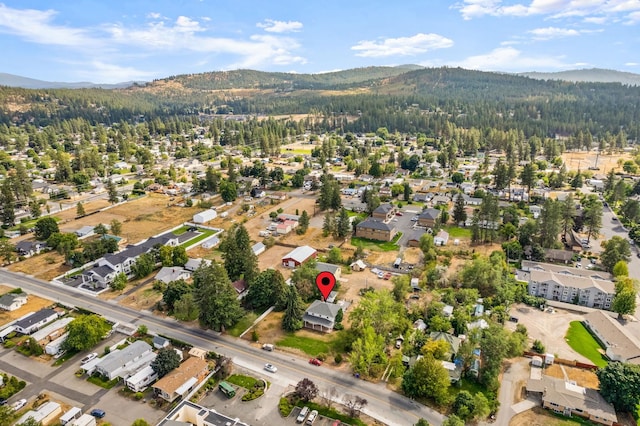 aerial view with a mountain view and a view of trees