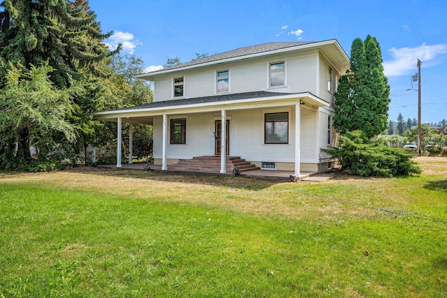 rear view of house featuring a lawn, a porch, and a shingled roof