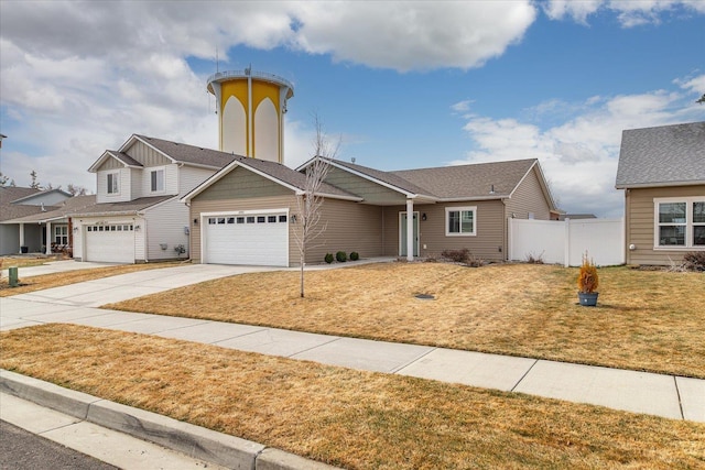 view of front of house with a front yard, fence, driveway, a garage, and board and batten siding