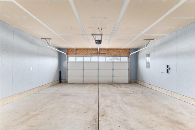 garage with electric panel and a garage door opener