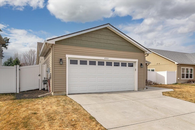 view of front of property with driveway, fence, a garage, and a gate