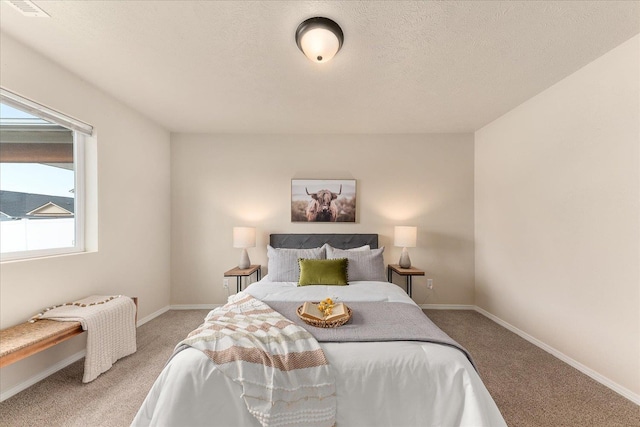 bedroom featuring visible vents, carpet, baseboards, and a textured ceiling