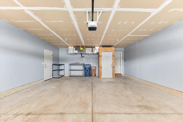 garage featuring a garage door opener and baseboards