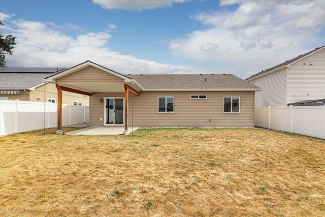 back of house featuring a lawn, a fenced backyard, and a patio area