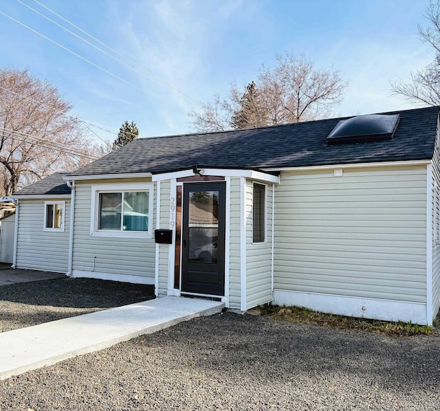 property entrance with a shingled roof