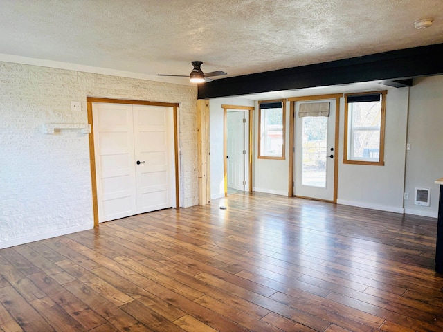 unfurnished bedroom featuring access to outside, visible vents, a textured ceiling, and wood-type flooring