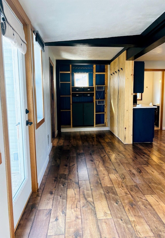 entrance foyer featuring beamed ceiling and hardwood / wood-style flooring