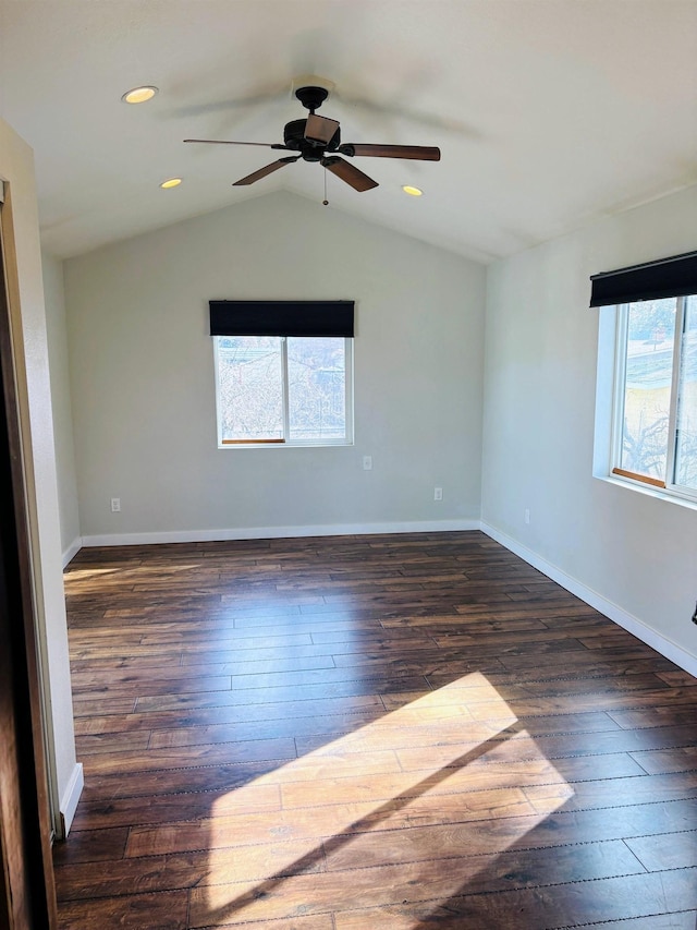 spare room featuring recessed lighting, baseboards, hardwood / wood-style floors, and vaulted ceiling