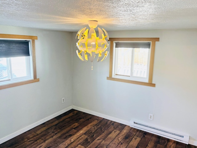 spare room featuring baseboards, a baseboard radiator, dark wood-type flooring, a textured ceiling, and a notable chandelier