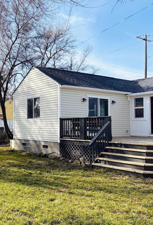 back of house featuring a wooden deck, a yard, roof with shingles, and crawl space