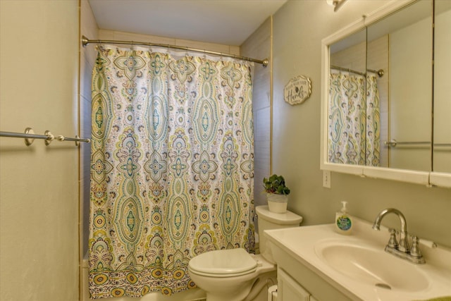 full bathroom featuring toilet, shower / bath combo, and vanity