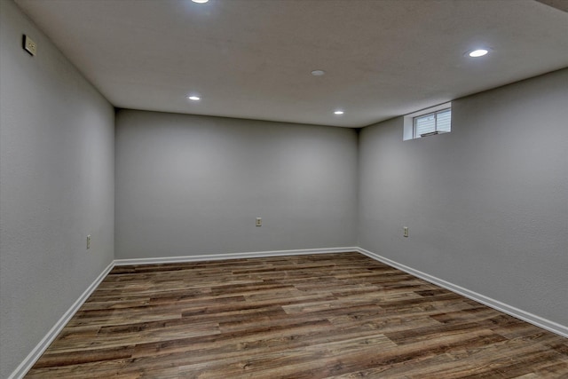 below grade area featuring recessed lighting, dark wood-type flooring, and baseboards