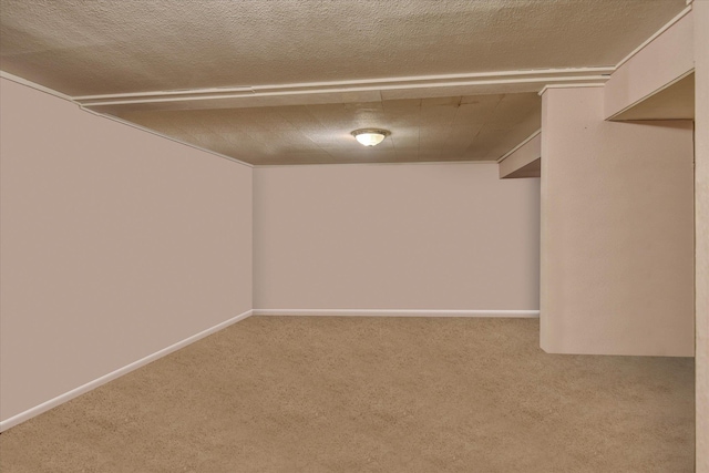 interior space with baseboards, carpet floors, and a textured ceiling