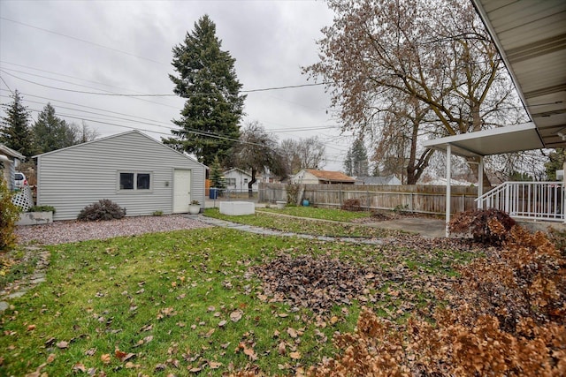 view of yard featuring an outdoor structure and fence