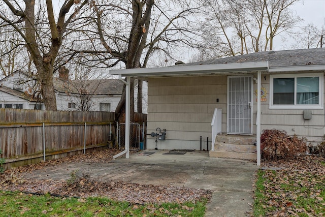 doorway to property featuring a patio area and fence