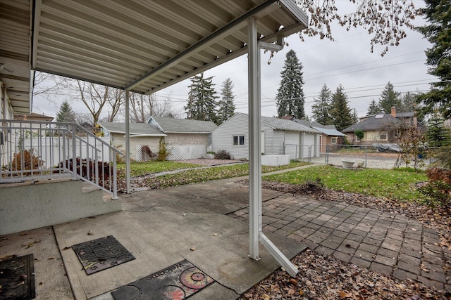 view of patio with an outdoor structure, fence, and a residential view