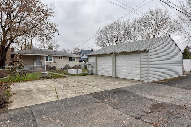 detached garage featuring fence