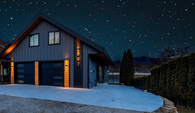 garage at twilight featuring driveway