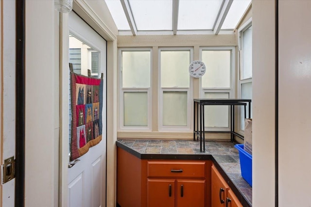 kitchen featuring tile countertops and brown cabinetry