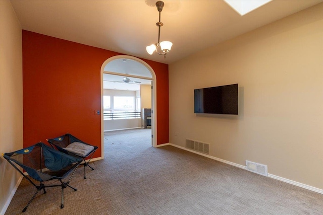 unfurnished room featuring baseboards, visible vents, carpet floors, and a chandelier