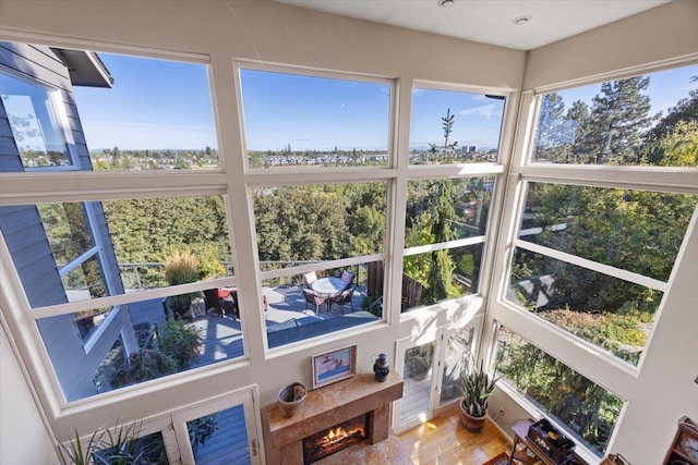 sunroom / solarium featuring plenty of natural light and a high end fireplace