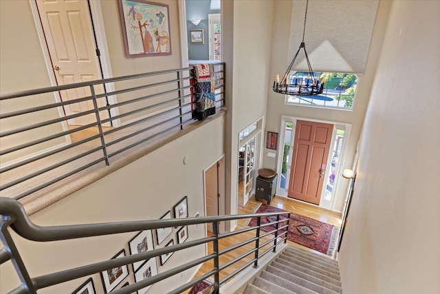 entryway featuring a notable chandelier, a high ceiling, and wood finished floors