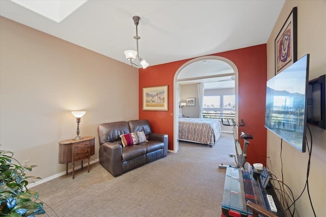 bedroom with baseboards and light colored carpet