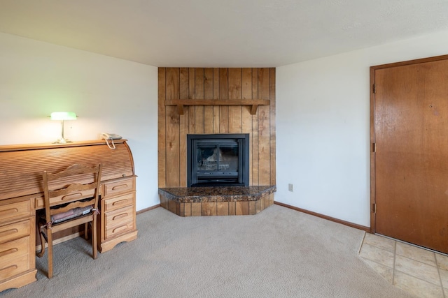 interior space with a fireplace, baseboards, and light carpet