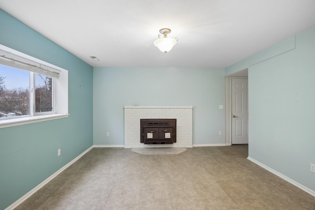 unfurnished living room featuring visible vents, baseboards, and carpet floors