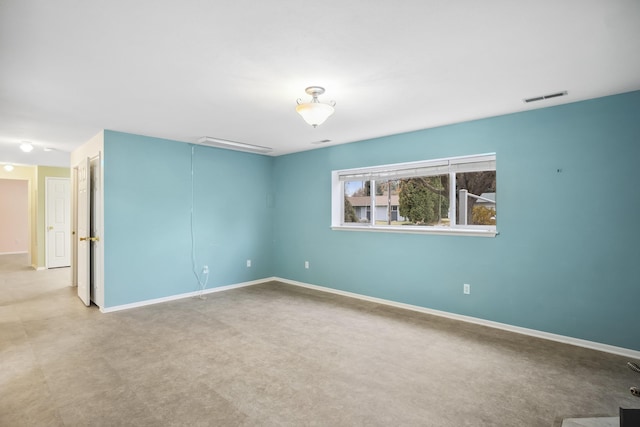 unfurnished room with visible vents and baseboards