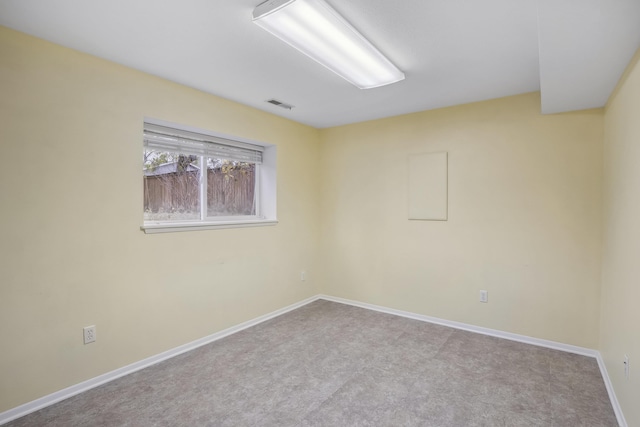 empty room featuring baseboards and visible vents