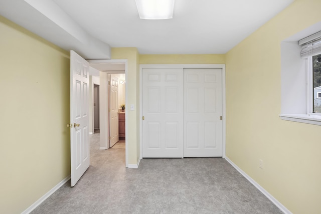 unfurnished bedroom featuring a closet and baseboards