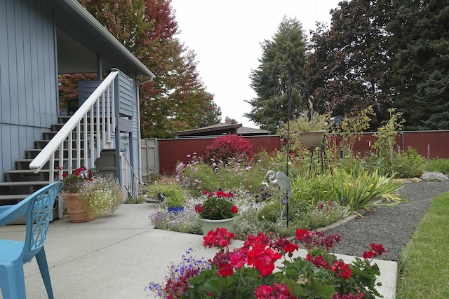 view of yard featuring stairway, a fenced backyard, and a patio area