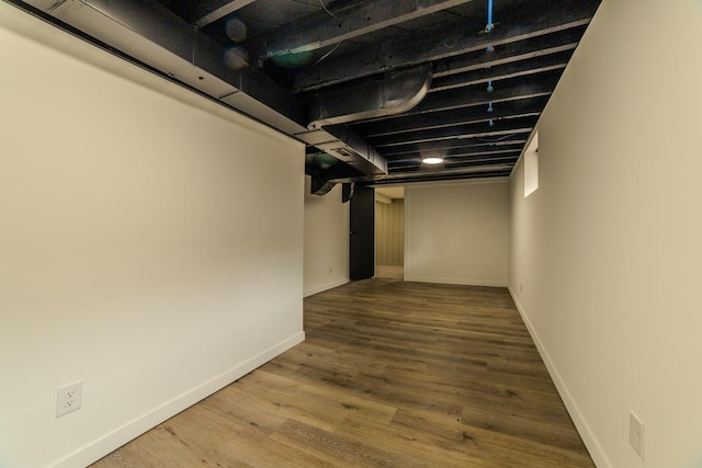 finished basement with baseboards and wood finished floors