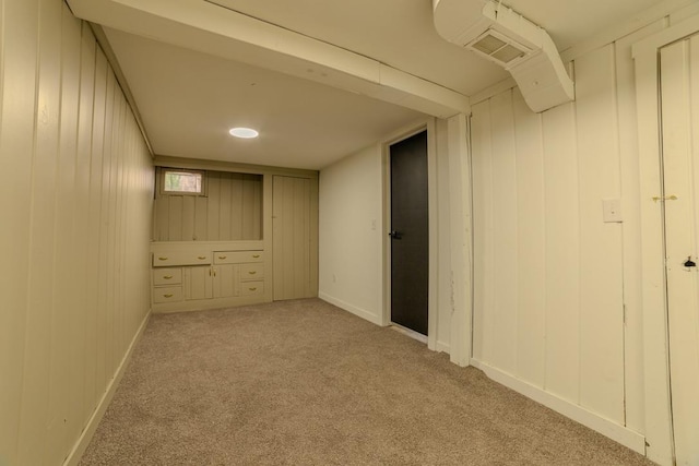 finished basement featuring baseboards and carpet floors