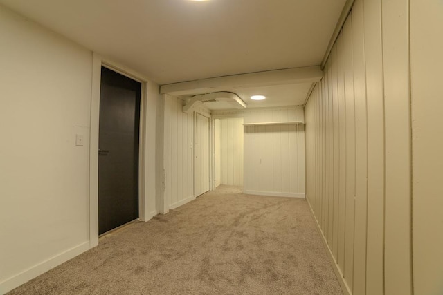 hall featuring baseboards and carpet floors