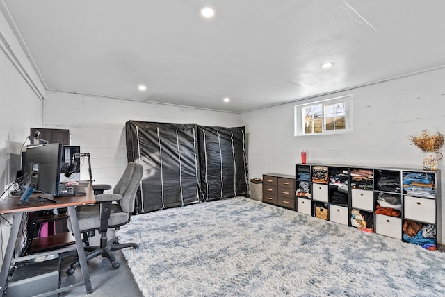 home office featuring concrete block wall, recessed lighting, and concrete flooring