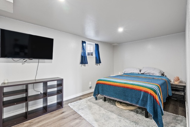 bedroom featuring wood finished floors and baseboards